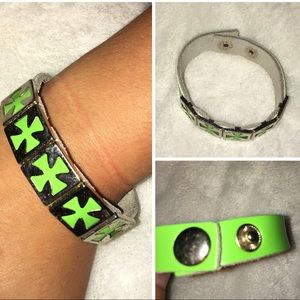 Neon leather bracelet with metal cross charms.